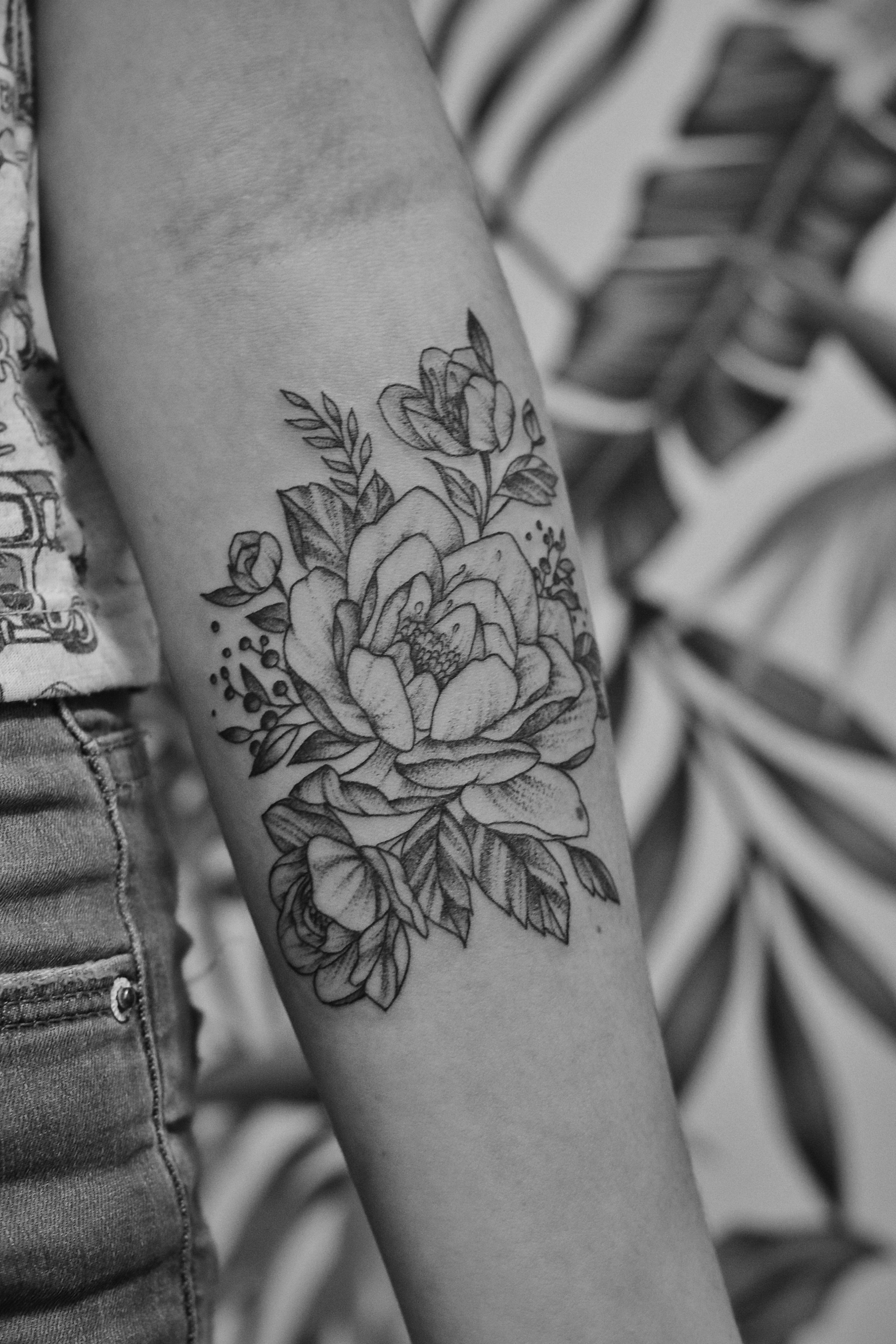 Fine line floral tattoo by Sara Bell